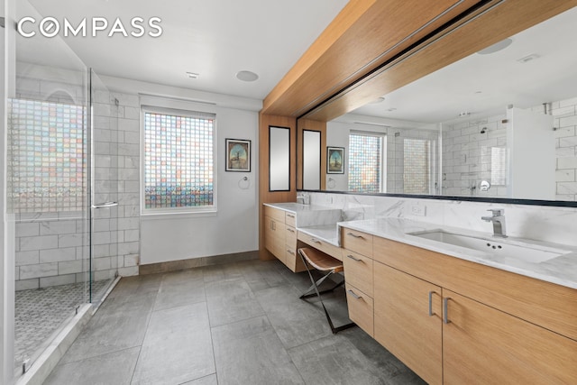 full bath featuring tile patterned floors, a shower stall, vanity, and baseboards