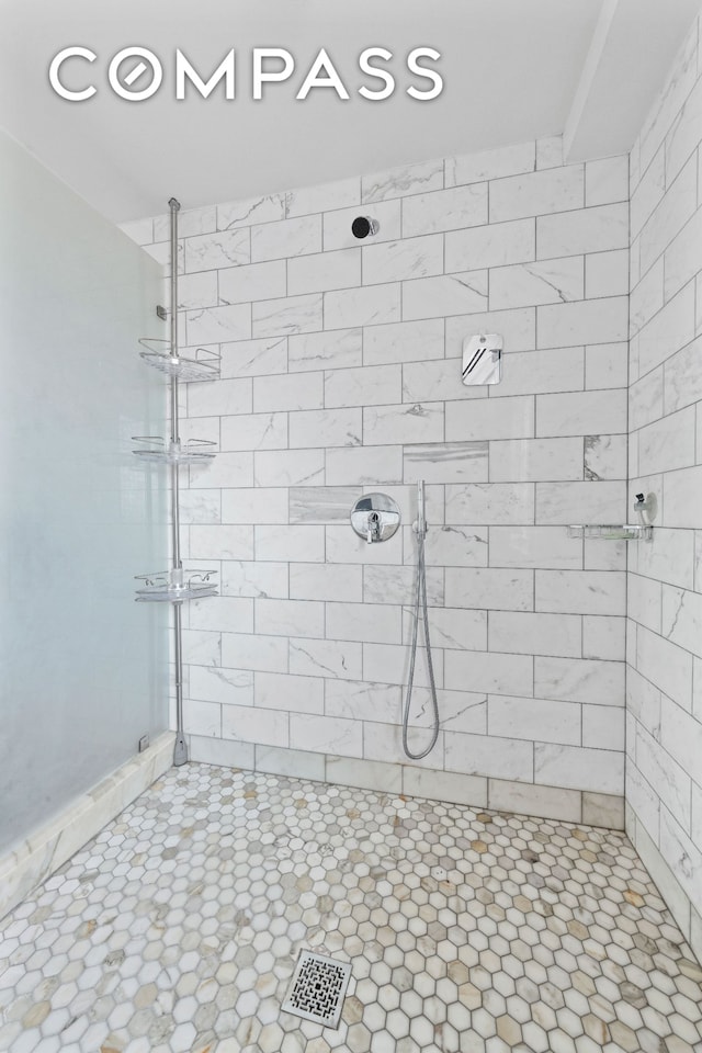 full bath featuring tiled shower