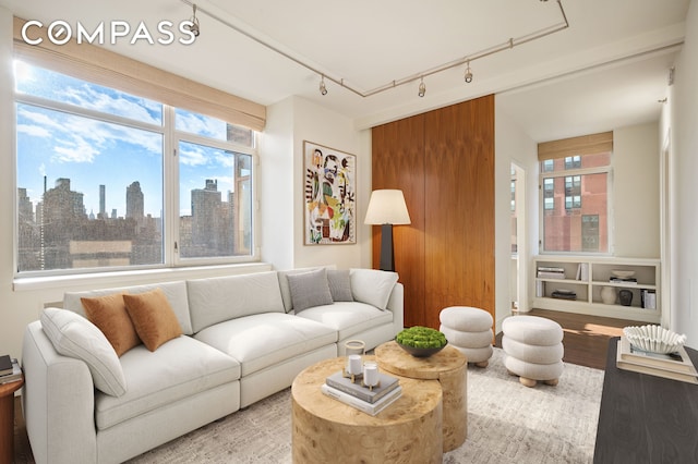 living area with a view of city and wood finished floors