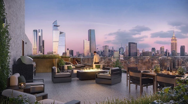 patio terrace at dusk featuring an outdoor fire pit