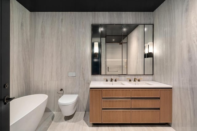 bathroom featuring tile walls, toilet, vanity, and a bathtub