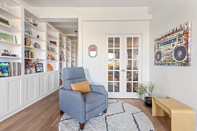 sitting room featuring hardwood / wood-style floors and french doors