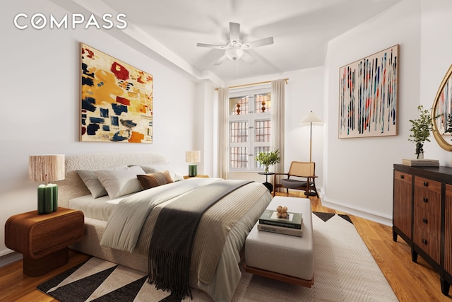 bedroom with light wood-type flooring, a ceiling fan, and baseboards
