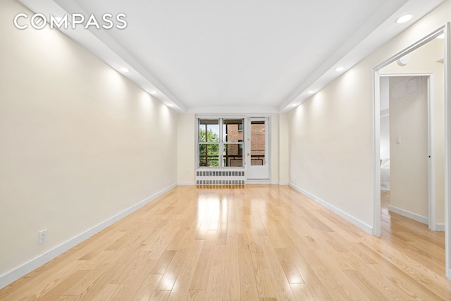 spare room with light wood-style flooring, baseboards, and recessed lighting