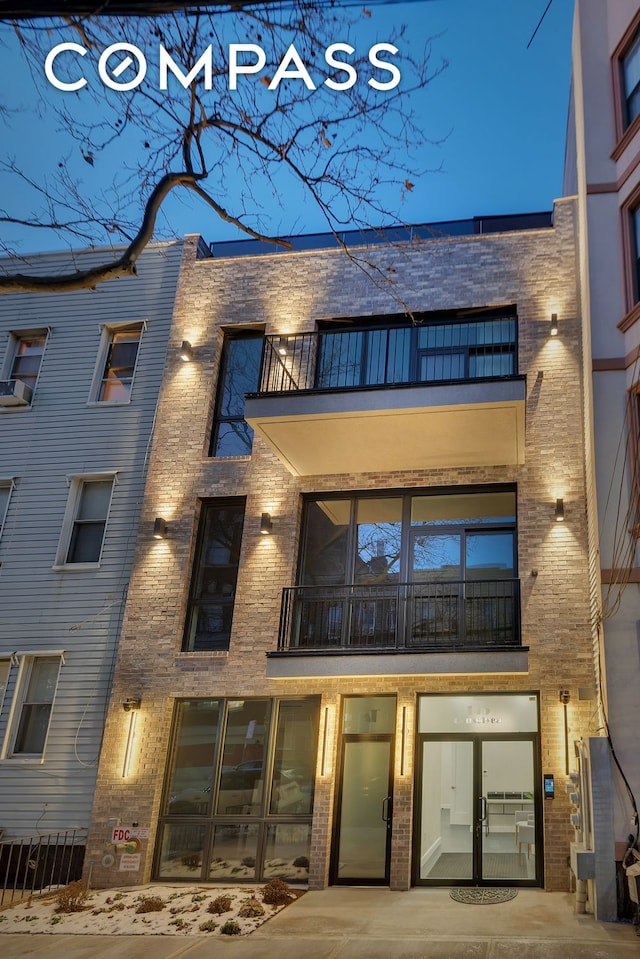 145 Conselyea St, New York City, NY 11211 - back of house with a balcony and brick siding