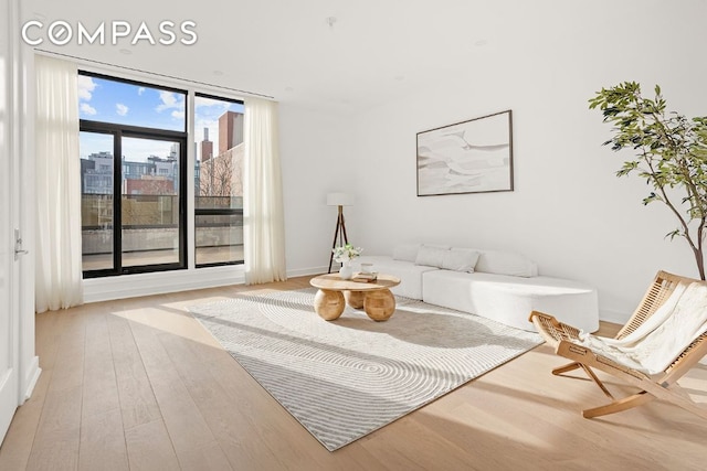 sitting room featuring light wood-style floors and a city view