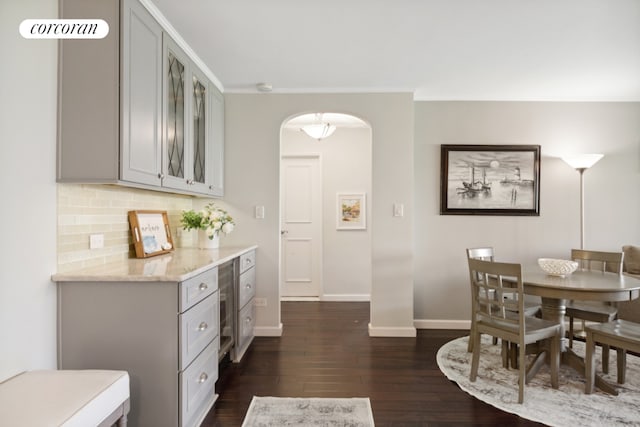 dining space featuring dark hardwood / wood-style floors and crown molding