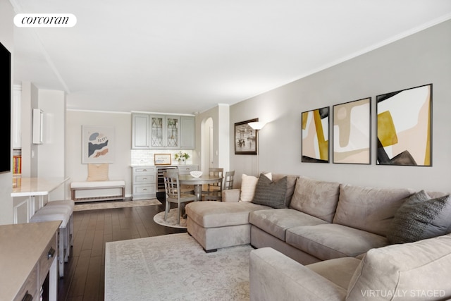 living room with crown molding, dark wood-type flooring, and wine cooler