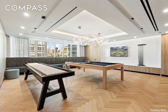 game room with a view of city, pool table, and a tray ceiling