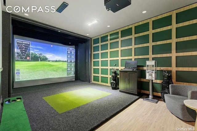 recreation room featuring golf simulator, wood finished floors, and recessed lighting