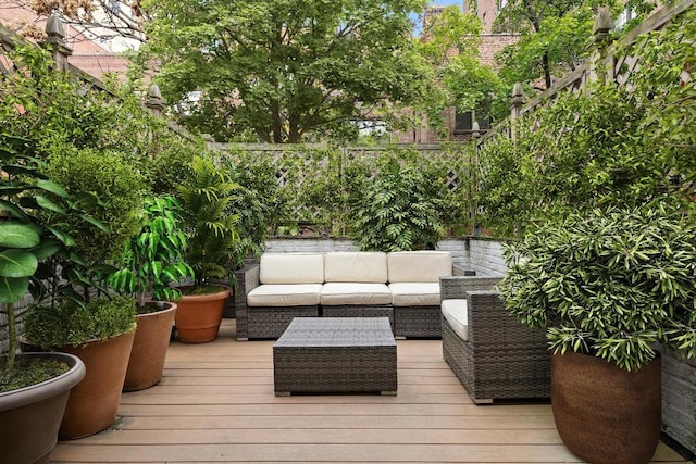 wooden deck with an outdoor living space