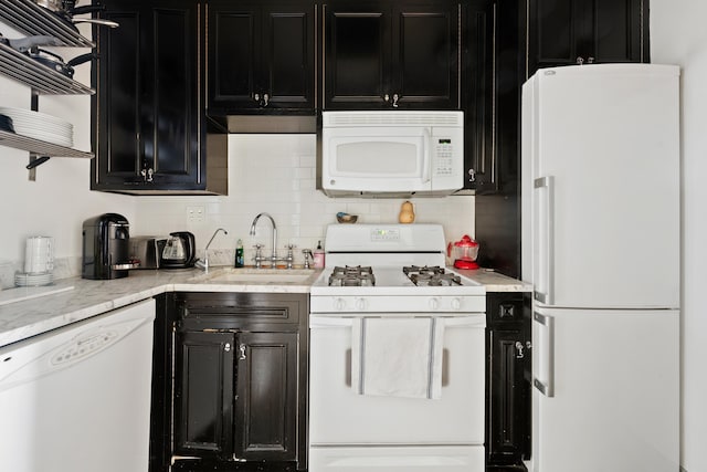 51 E 75th St, New York City, NY 10021 - kitchen featuring white appliances, dark cabinetry, open shelves, and decorative backsplash