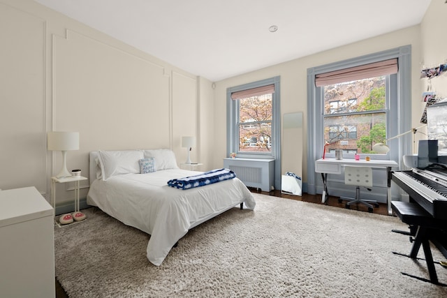 51 E 75th St, New York City, NY 10021 - bedroom featuring radiator, multiple windows, and wood finished floors