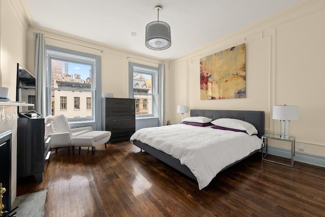 bedroom featuring multiple windows, crown molding, and dark hardwood / wood-style flooring