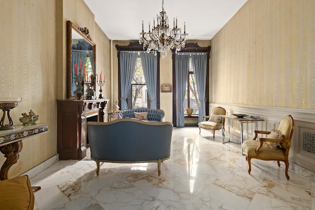 51 E 75th St, New York City, NY 10021 - sitting room featuring wallpapered walls, a chandelier, marble tiled flooring, and wainscoting