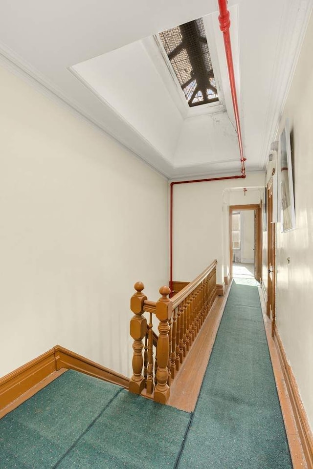 117 W 75th St Unit Twnh, New York City, NY 10023 - corridor featuring ornamental molding, a raised ceiling, an upstairs landing, and baseboards