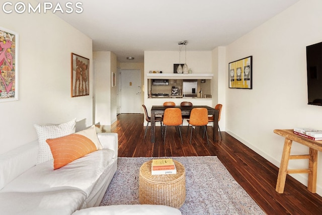 living room with dark hardwood / wood-style flooring and sink