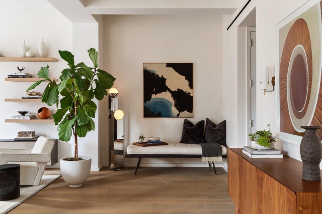 living room with light hardwood / wood-style flooring and beam ceiling