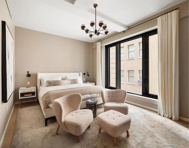 bedroom with beamed ceiling and a notable chandelier