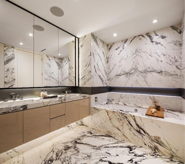 bathroom featuring vanity and a bath