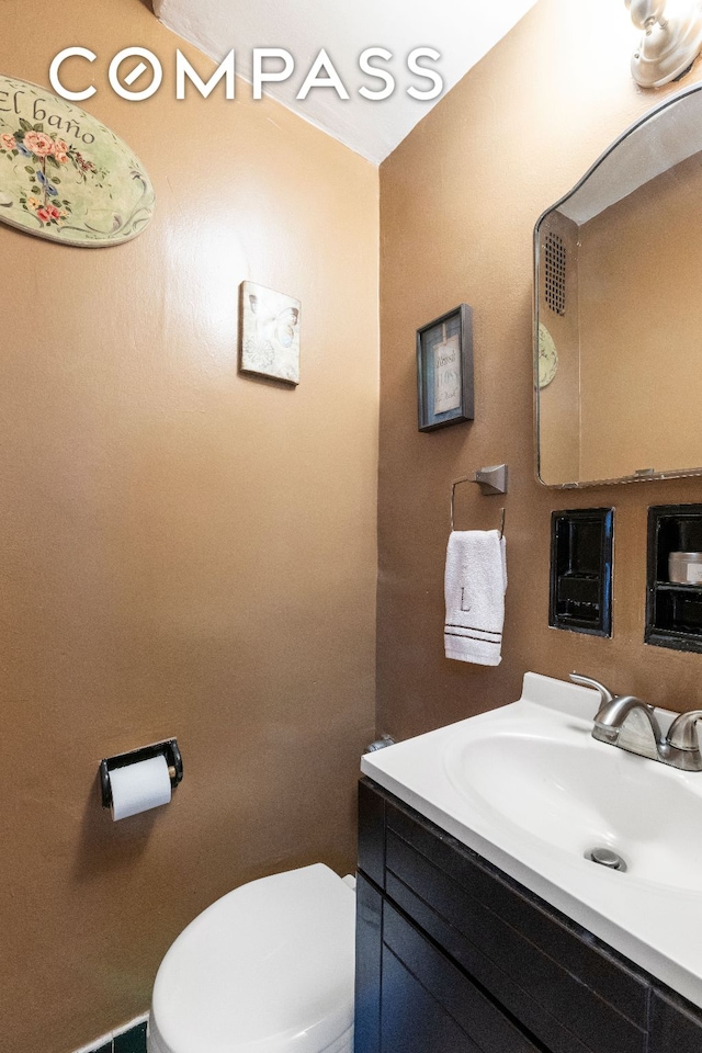 bathroom featuring vanity and toilet