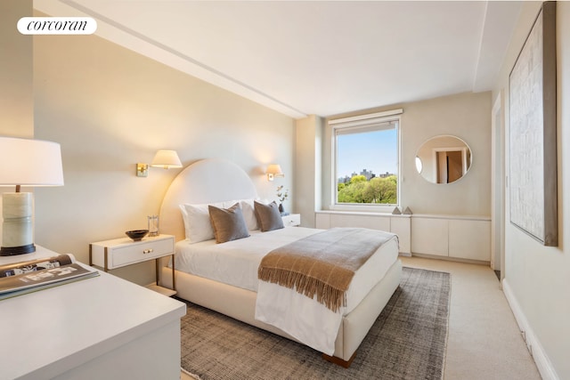 bedroom with baseboards, visible vents, and light colored carpet