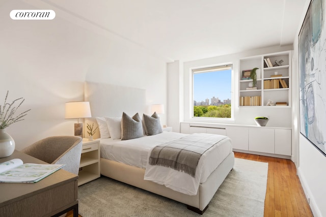 bedroom with light wood-type flooring and visible vents