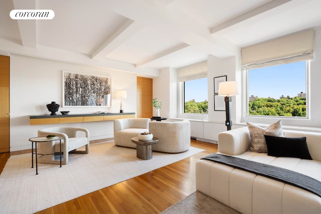 living room featuring visible vents, beamed ceiling, and wood finished floors