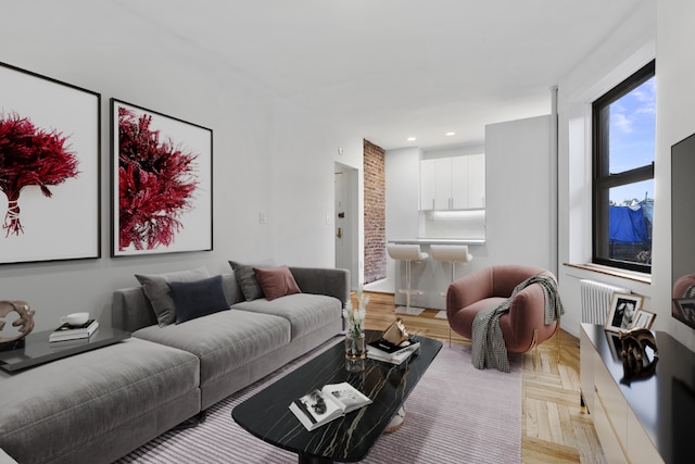 living room with light parquet floors and radiator heating unit