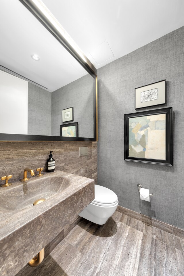 bathroom featuring a sink, toilet, and wood finished floors