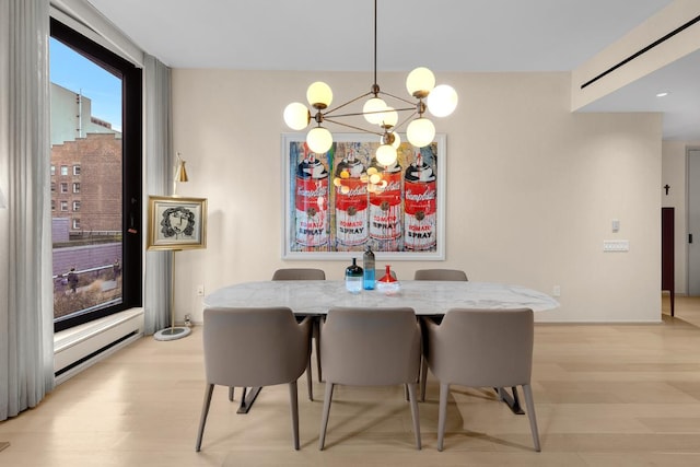 dining room featuring an inviting chandelier and light hardwood / wood-style floors