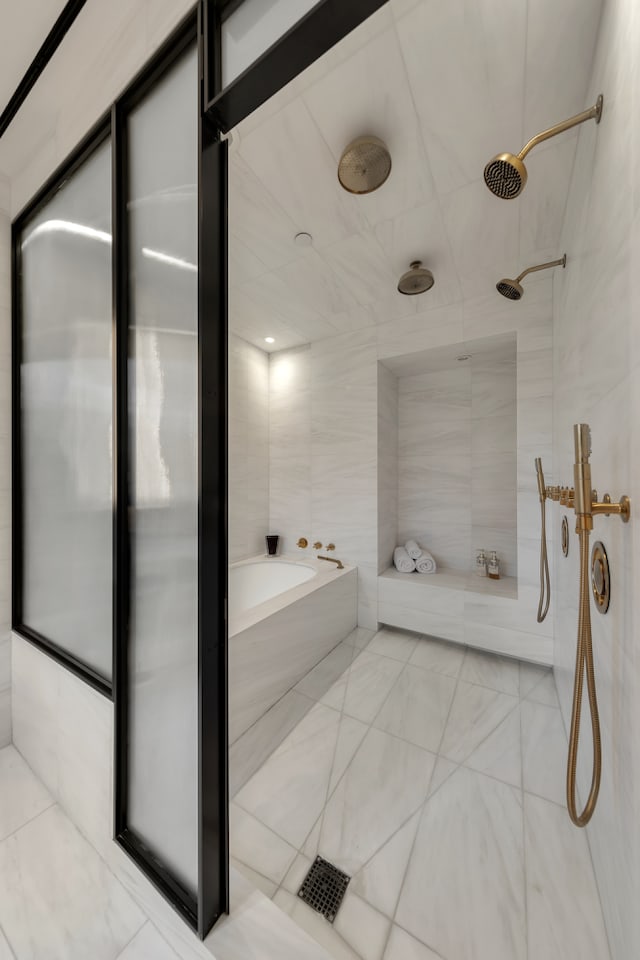 full bath featuring a stall shower, a garden tub, and tile walls