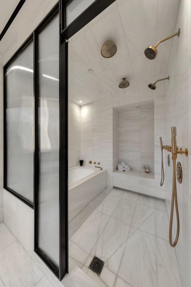 bathroom with a tub and a tile shower