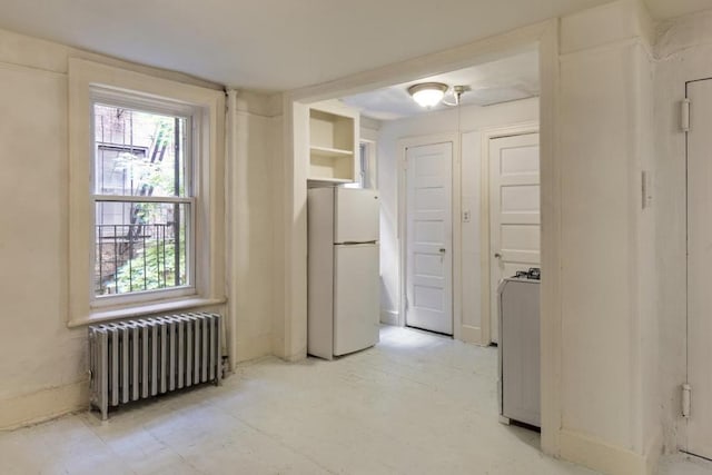 hall featuring plenty of natural light and radiator heating unit