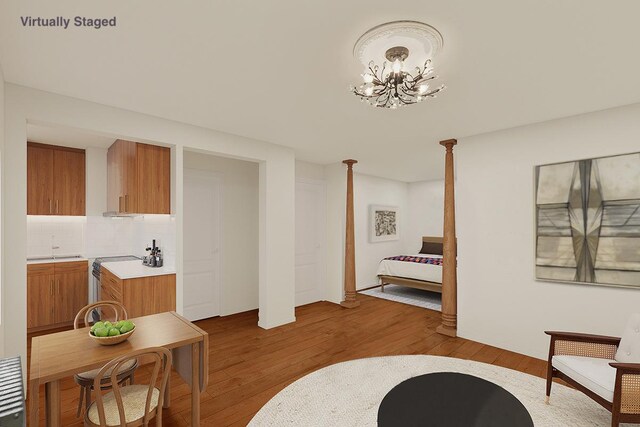 living area featuring an inviting chandelier and light wood-type flooring