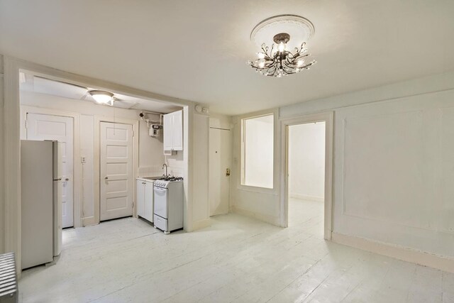 empty room featuring radiator heating unit, a chandelier, and cooling unit