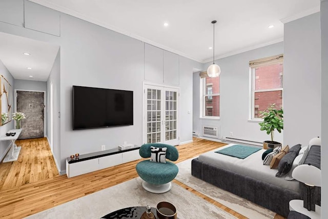 bedroom with a baseboard heating unit, french doors, ornamental molding, and hardwood / wood-style floors