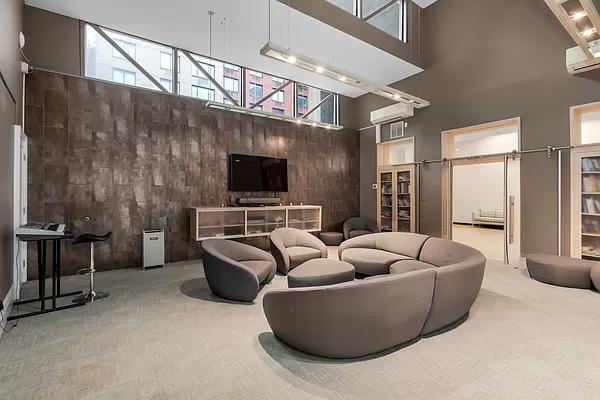 carpeted cinema room with a high ceiling