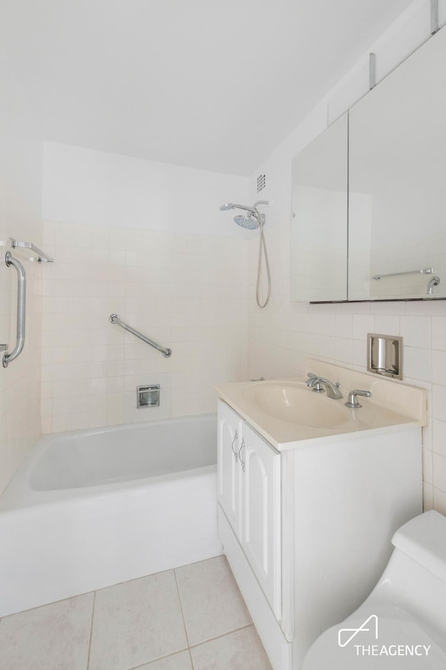 full bathroom with tile walls, visible vents, toilet, vanity, and tile patterned floors