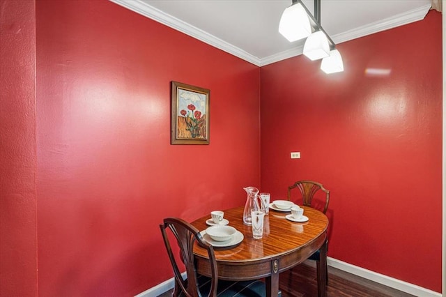 dining area with crown molding and hardwood / wood-style flooring