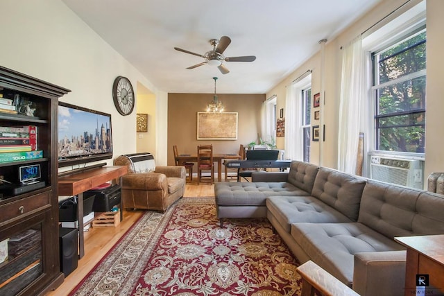 living room featuring ceiling fan, cooling unit, and light wood-type flooring