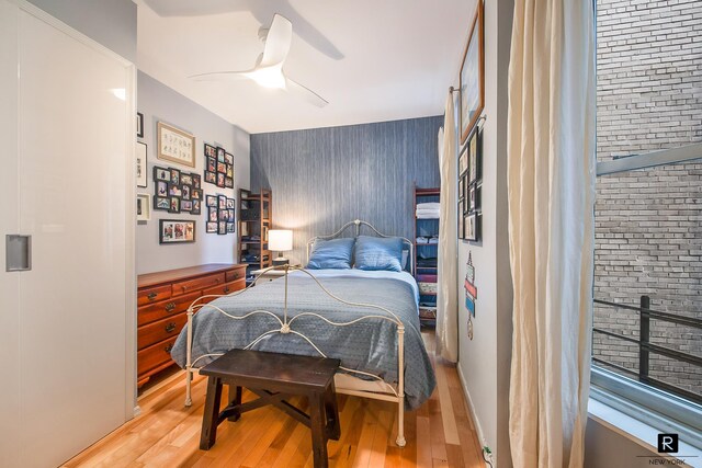 bedroom featuring ceiling fan and light hardwood / wood-style flooring