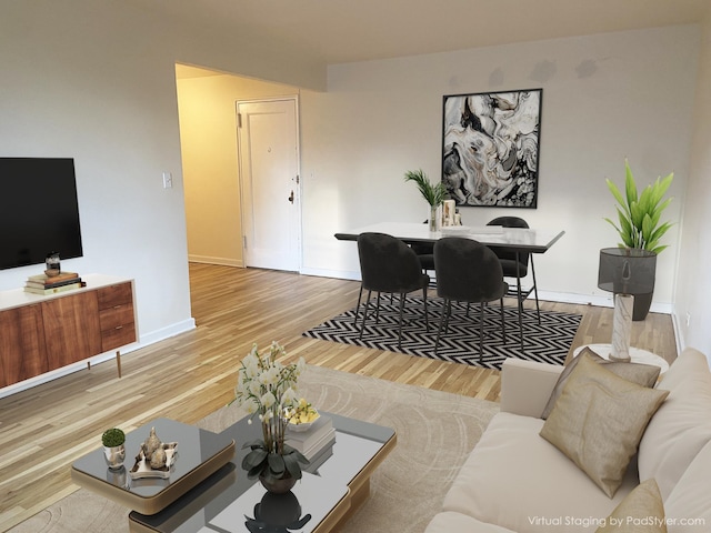 living area with wood finished floors and baseboards