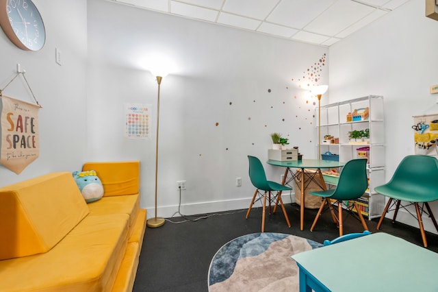 dining space with a drop ceiling