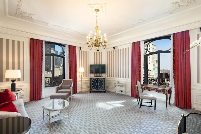 carpeted living area featuring a decorative wall and an inviting chandelier