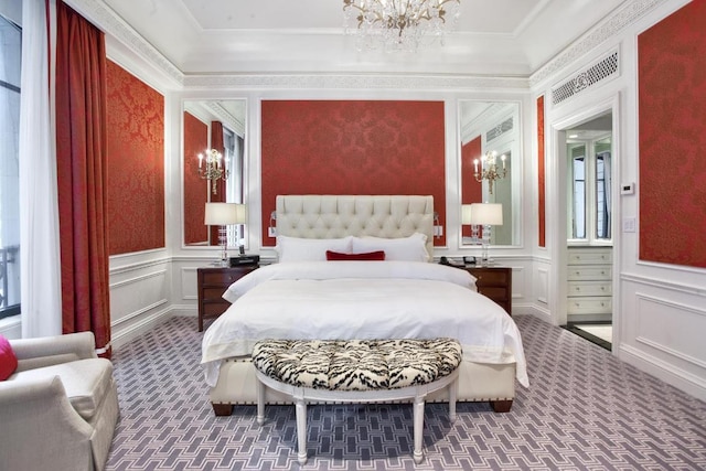 bedroom with ornamental molding, carpet, and an inviting chandelier