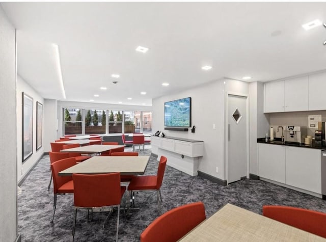 carpeted dining room featuring sink