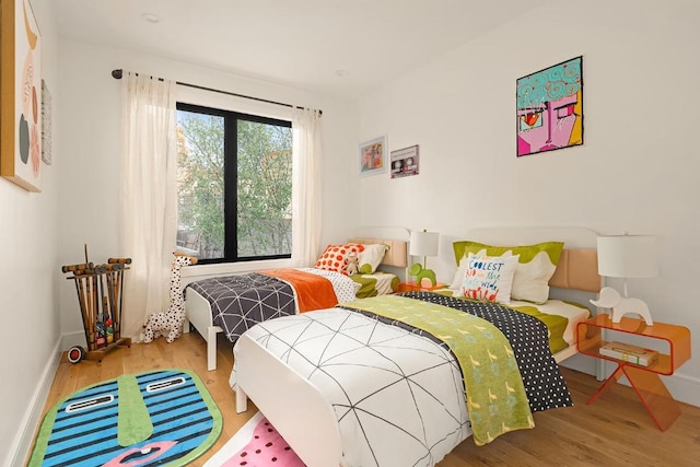 bedroom with wood-type flooring