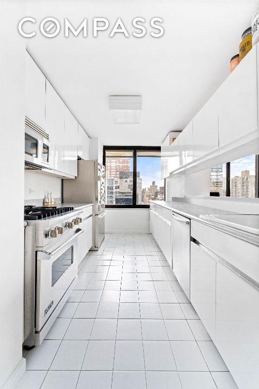 kitchen featuring white cabinetry, light tile patterned floors, and appliances with stainless steel finishes