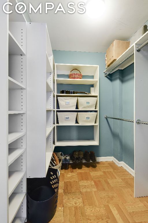 walk in closet featuring light parquet flooring